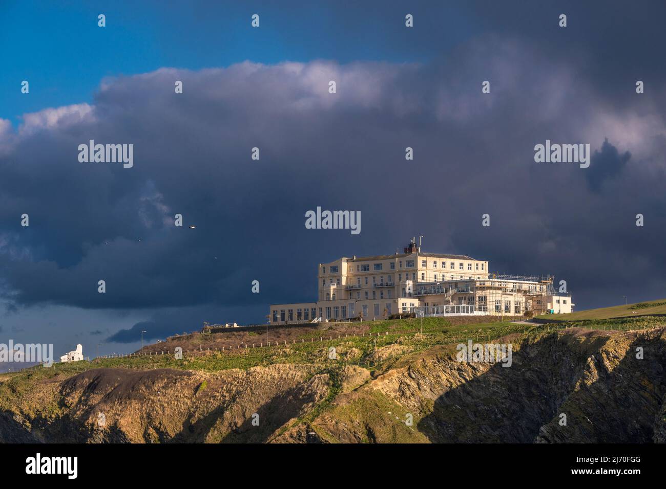 Evening light over the Atlantic Hotel on the coast overlooking Newquay Bay in Cornwall in the UK. Stock Photo