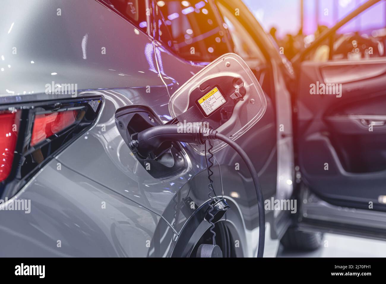 EV Car at charging station, Electric car green energy and eco power concept. Stock Photo