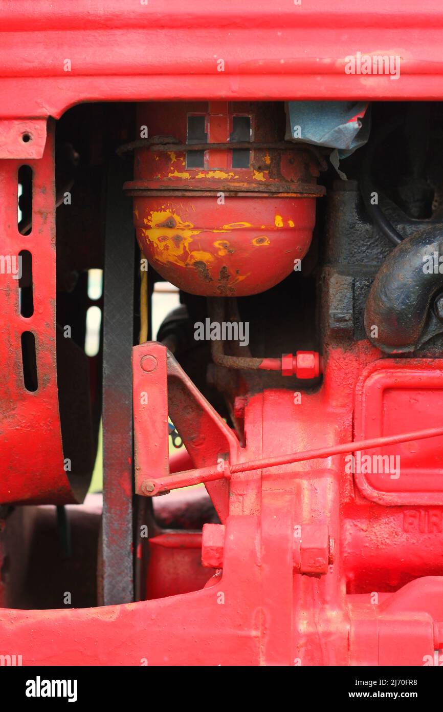Traditional vintage bright red tractor mechanical engine and frame ...