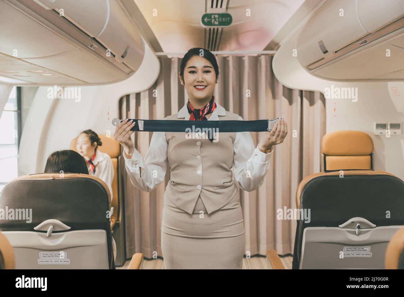 Air hostess Demonstration In-Flight Safety instrument instructions to Cabin crew on Preflight Stock Photo