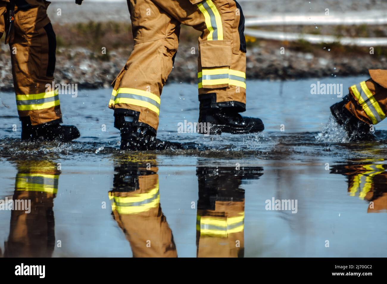 Firefighters from the 316th Civil Engineer Squadron walk through water ...