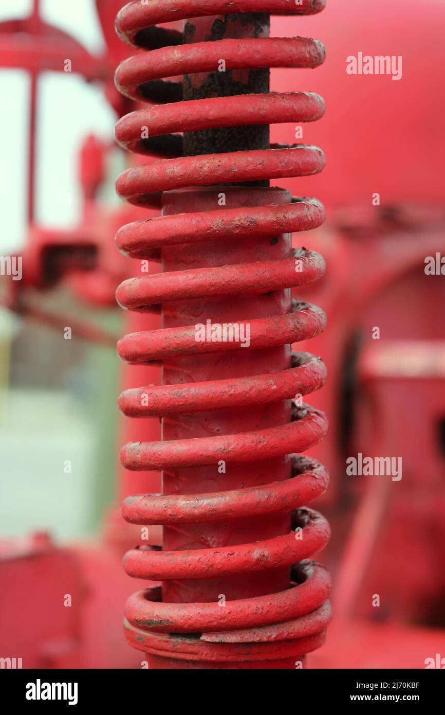 Traditional vintage bright red tractor mechanical engine and frame ...