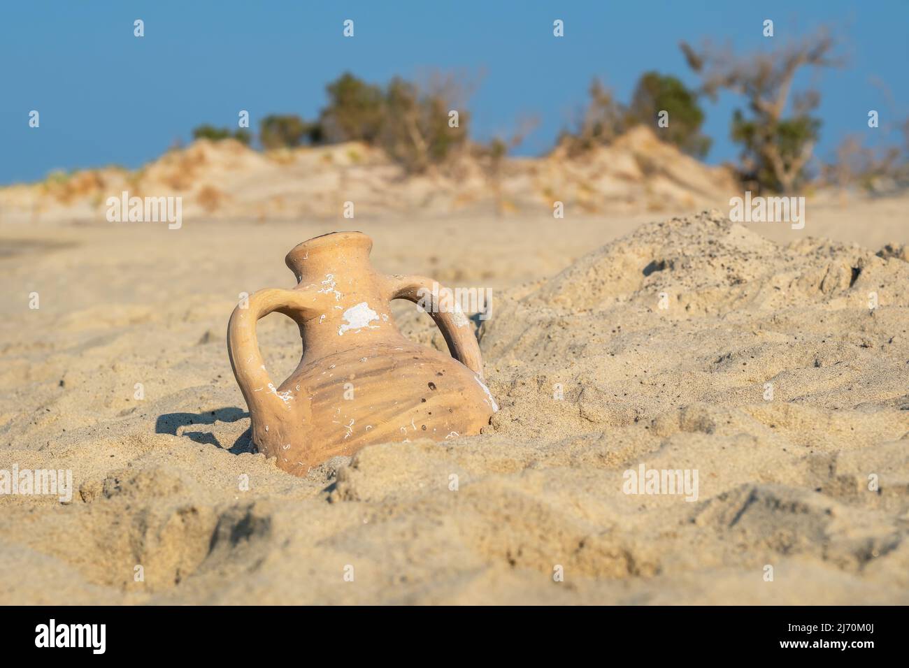 View to greek amphora on a sandy beach. Greece Stock Photo