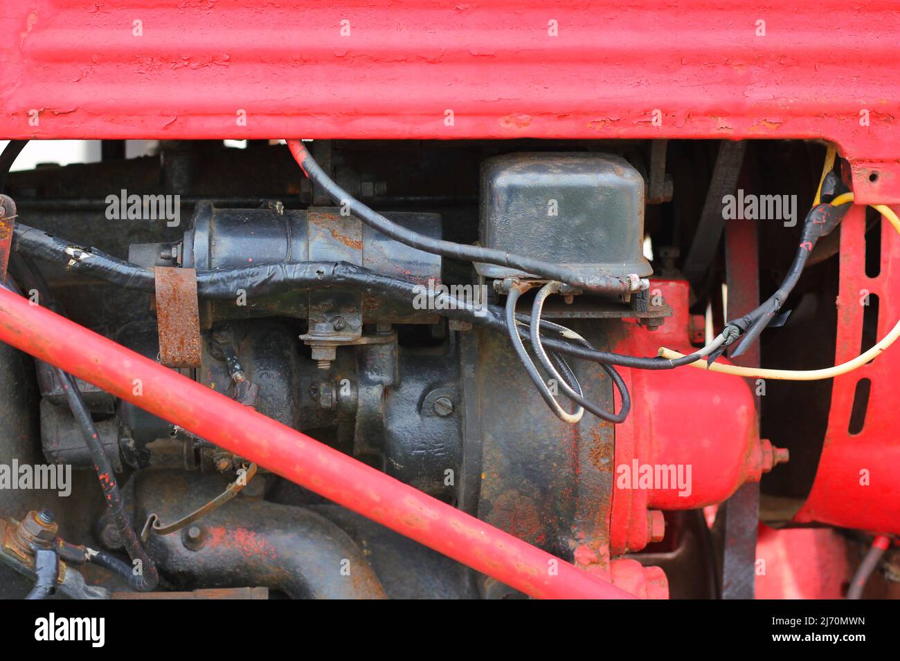 Traditional vintage bright red tractor mechanical engine and frame ...