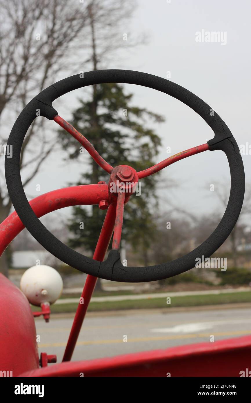 Traditional vintage bright red tractor mechanical engine and frame ...