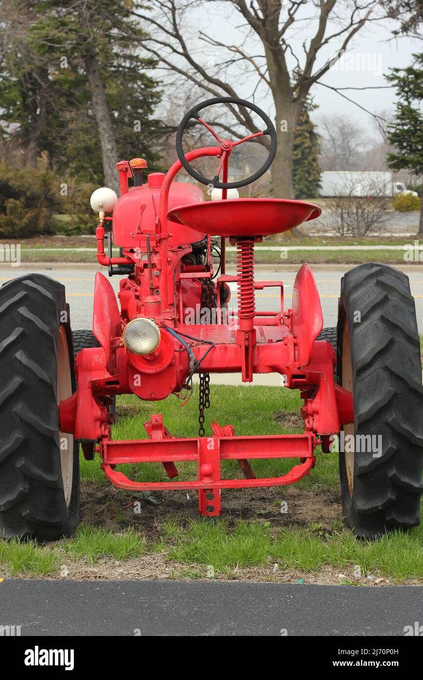 Traditional vintage bright red tractor mechanical engine and frame ...