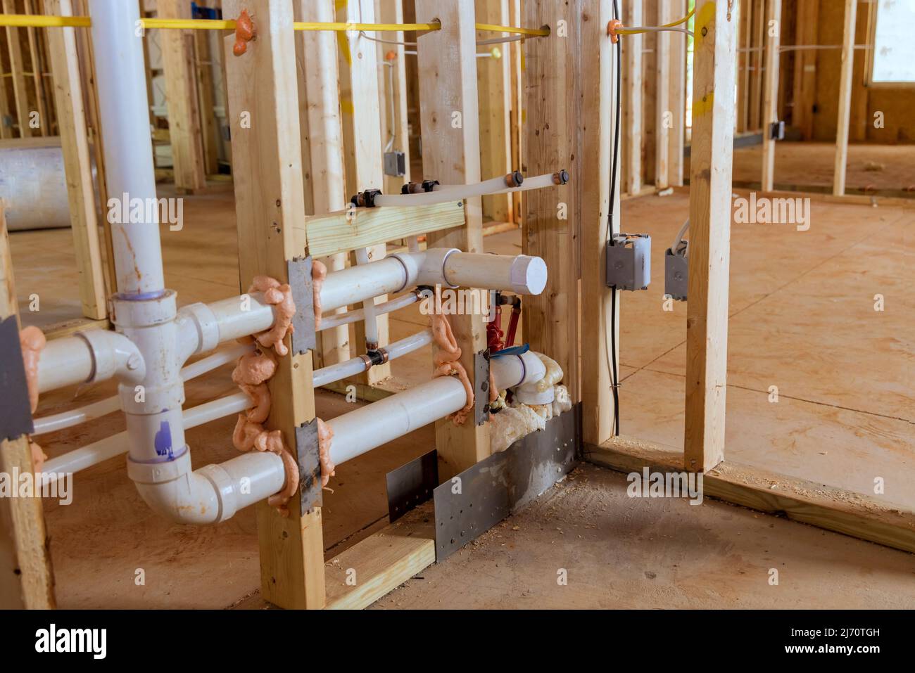 A under construction new building with hot and cold pex pipe layout PVC waste water system Stock