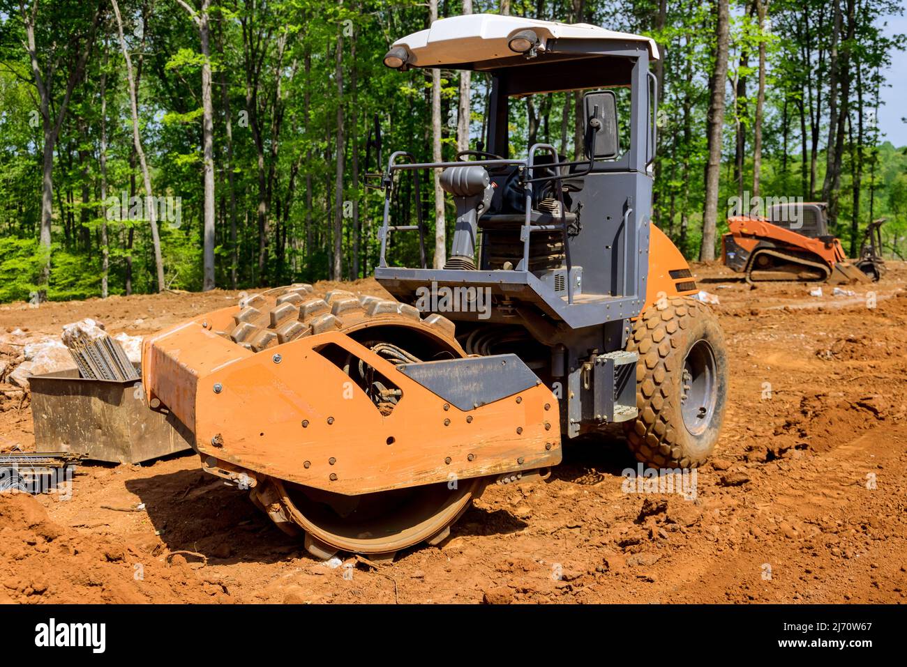 Heavy tractor machinery excavator align the earth doing landscaping Stock Photo