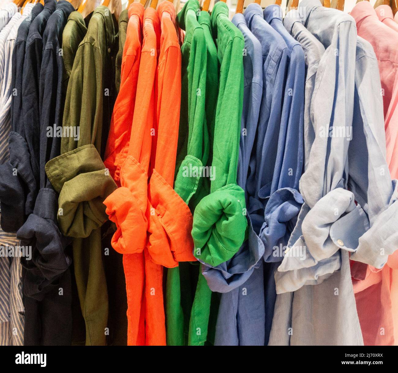 Colourful shirts on display in department store. Stock Photo
