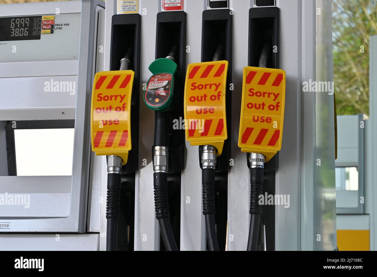 A fuel station pump station with 3 of the 4 fuel pumps stating that they are sorry they are out of use, no diesel fuel available, unleaded petrol. Stock Photo