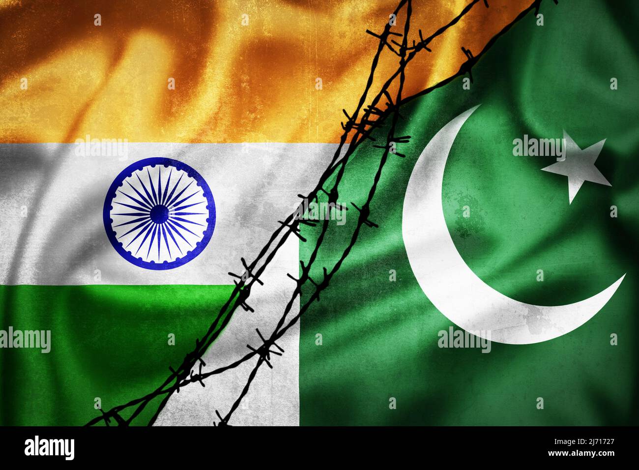 Grunge flags of India and Pakistan divided by barb wire illustration, concept of tense relations between India and Pakistan Stock Photo
