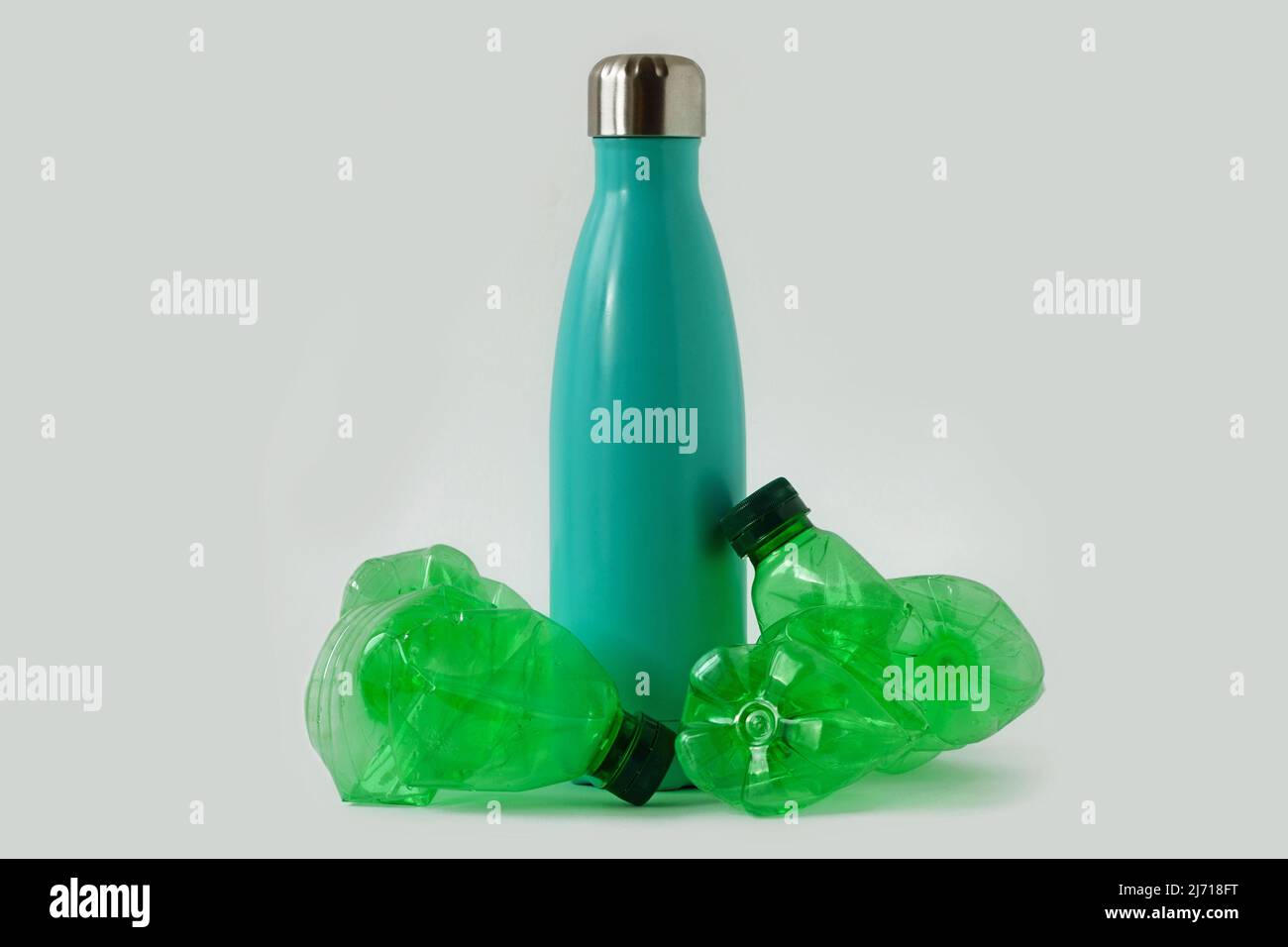 Aluminium stainless thermo bottle with plastic bottles on white background - Concept of ecology and stop plastic pollution Stock Photo