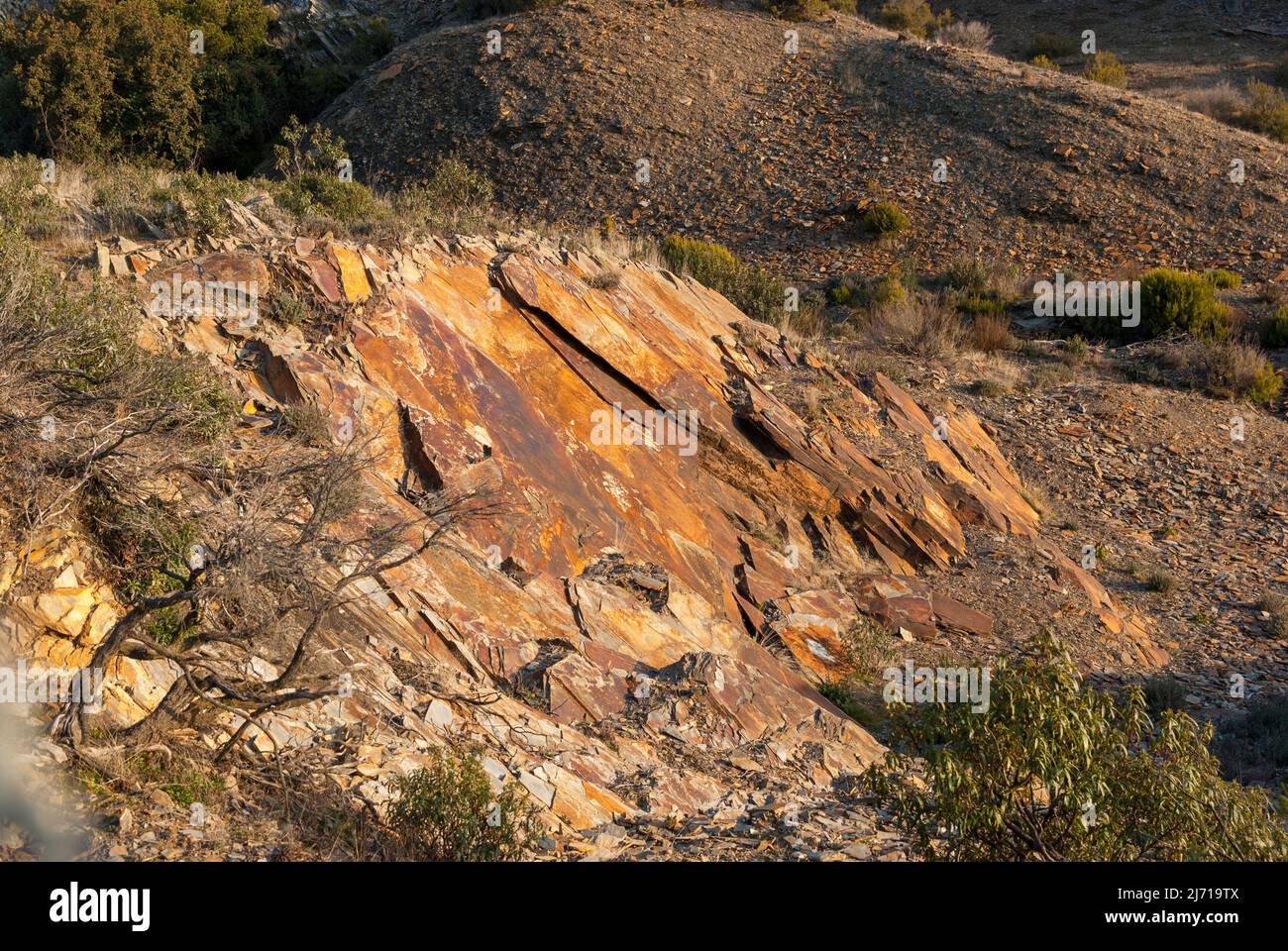 Sale of slate, old orange red slate stone extraction mine Stock Photo