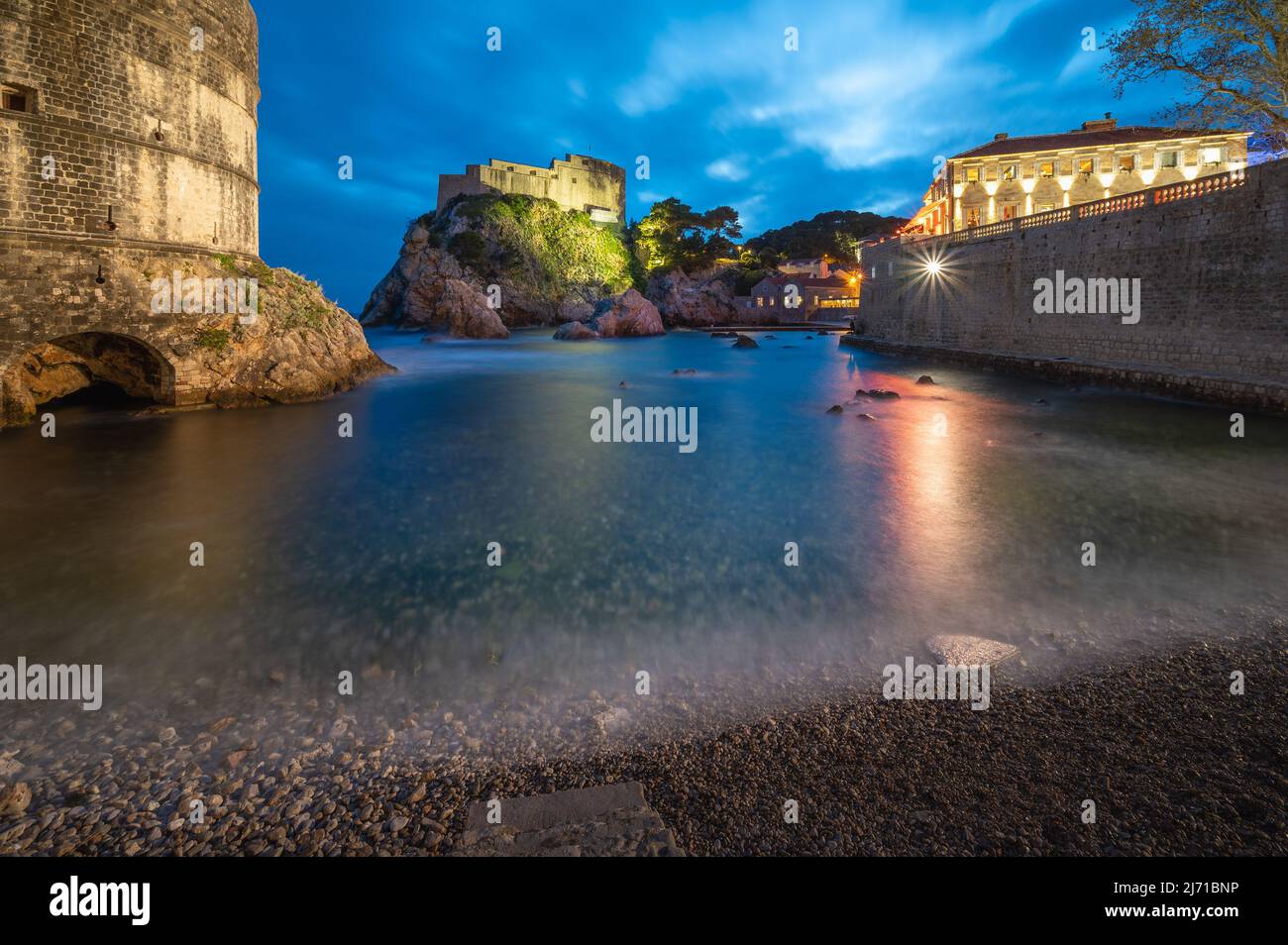 Dubrovnik West Harbor and Castle at Night Stock Photo