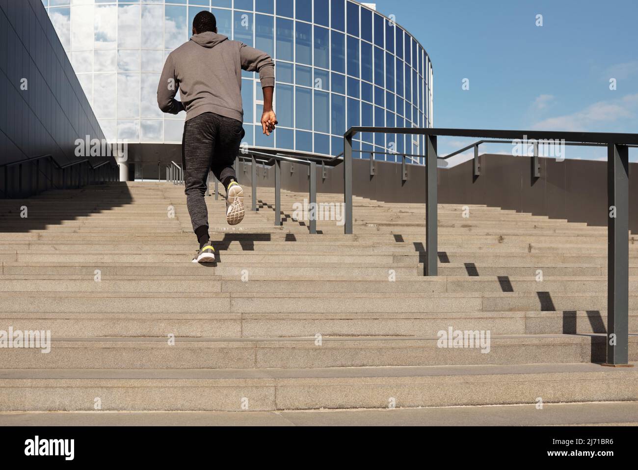 Black man running up stairs hi-res stock photography and images - Alamy