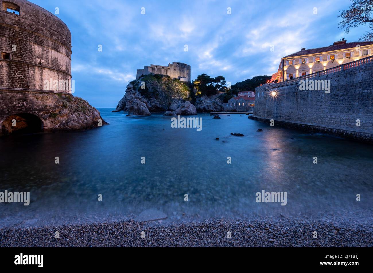 Dubrovnik West Harbor and Castle at Night Stock Photo