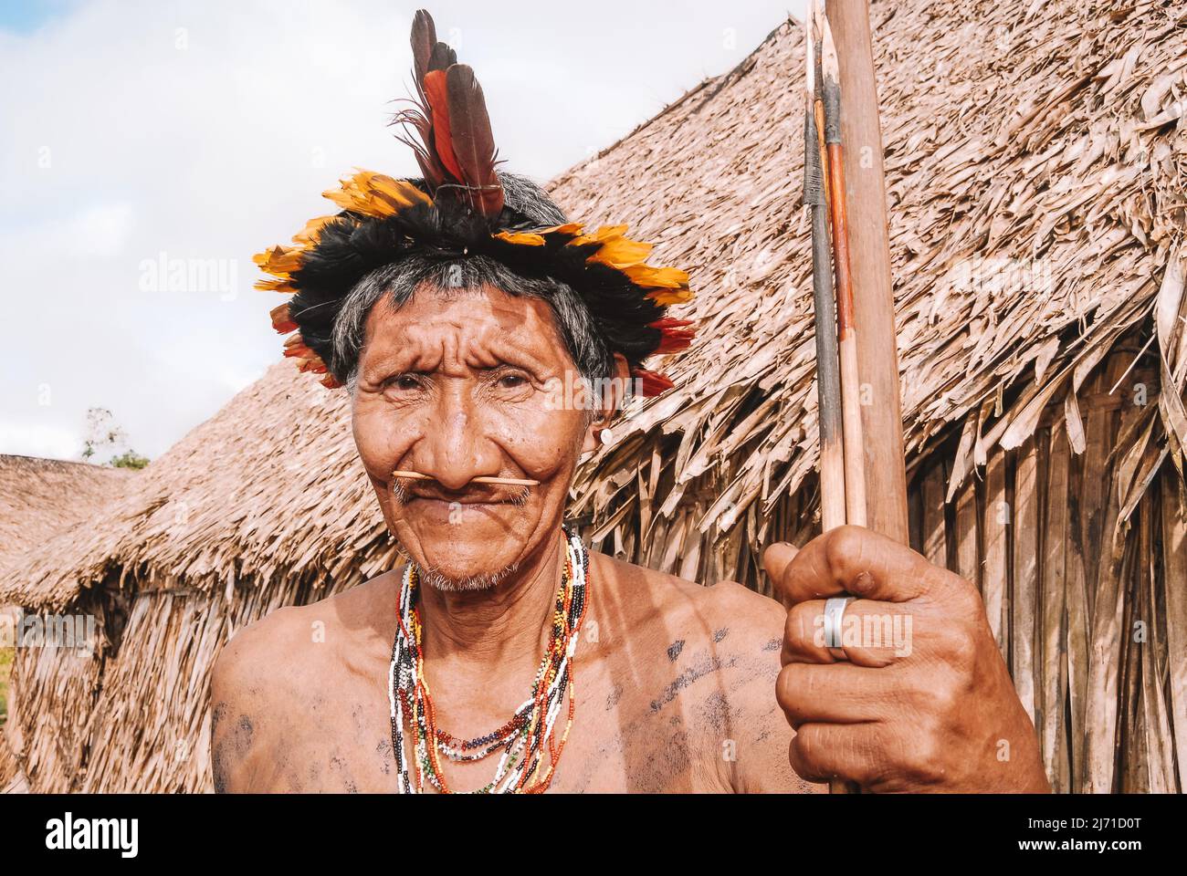 Indigenous man wearing a headdress known as cocar, leader of Arara do Laranjal tribe, near Xingu River in the Brazilian Amazon. 2007. Stock Photo