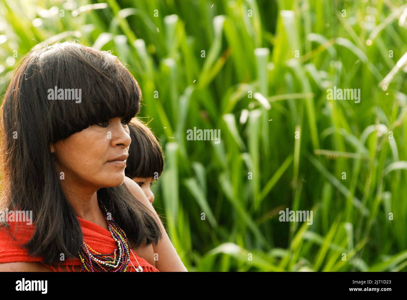 Indian mother from the Arawete Amazon tribe in Brazil carrying baby on a sling, 2007. Stock Photo