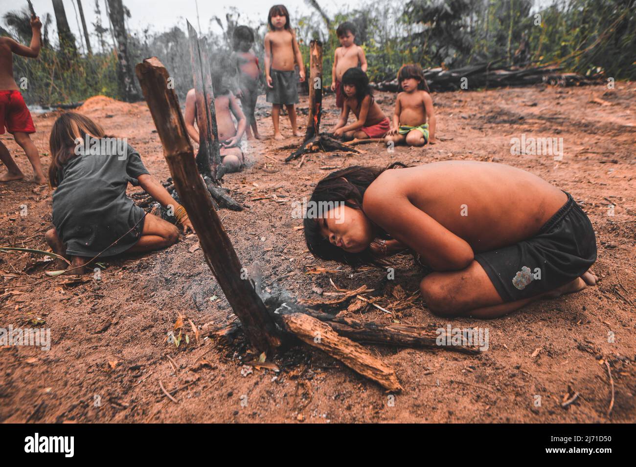 Indigenous children from a Brazilian Amazon tribe learning to make fire. Baixo Amazonas, Pará State, Amazon, Brazil. 2010. Stock Photo