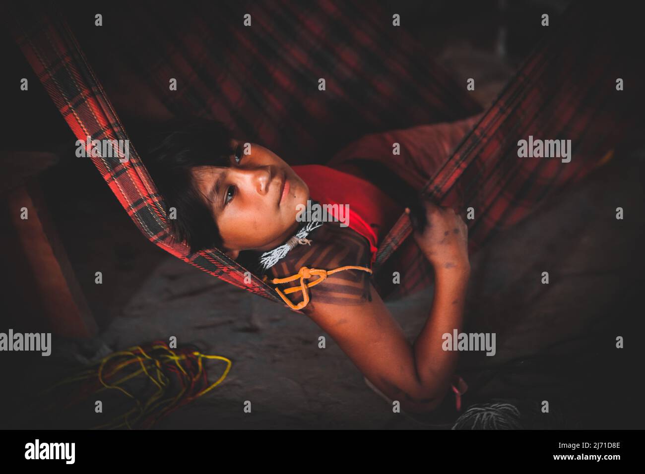 Indian boy resting on a hammock. Indigenous tribes of Baixo Amazonas, Pará, Amazon, Brazil. 2010. Stock Photo