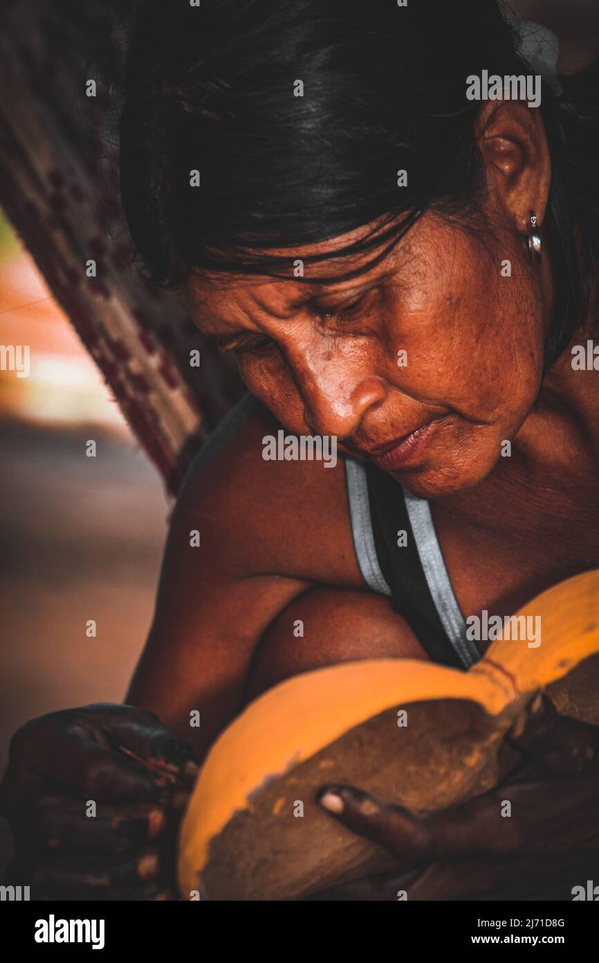 Indian woman crafting an indigenous art piece. Brazilian  Amazon, 2010. Stock Photo
