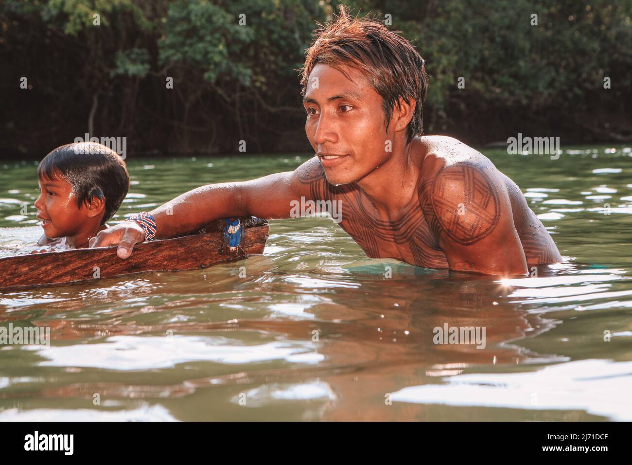 Young indian man from the Asurini Amazon tribe bathing in the Xingu  River. Brazil, 2009. Stock Photo