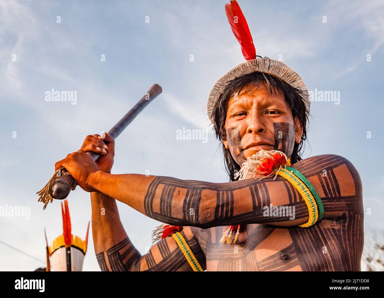 Indigenous man from a Brazilian Amazon tribe wearing feather headdress called cocar. Xingu River, Amazon, Brazil. 2010. Stock Photo