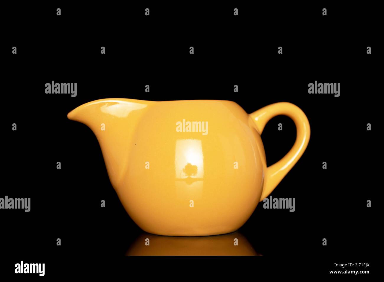 https://c8.alamy.com/comp/2J71EJX/one-ceramic-milk-jug-close-up-isolated-on-a-black-background-2J71EJX.jpg