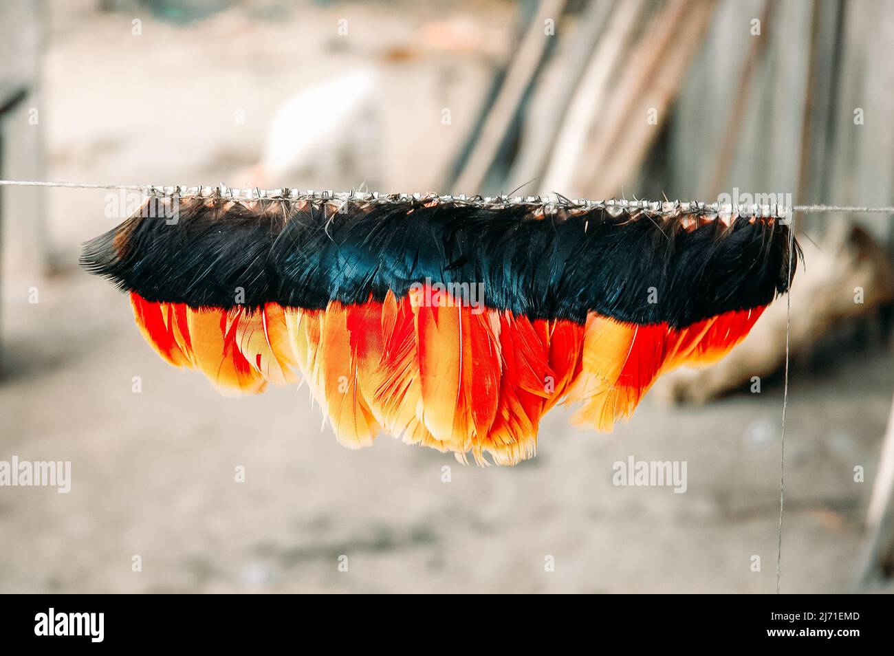 Indian headdress made of multi coloured bird feathers by members of a Brazilian tribe in the Amazon. Stock Photo