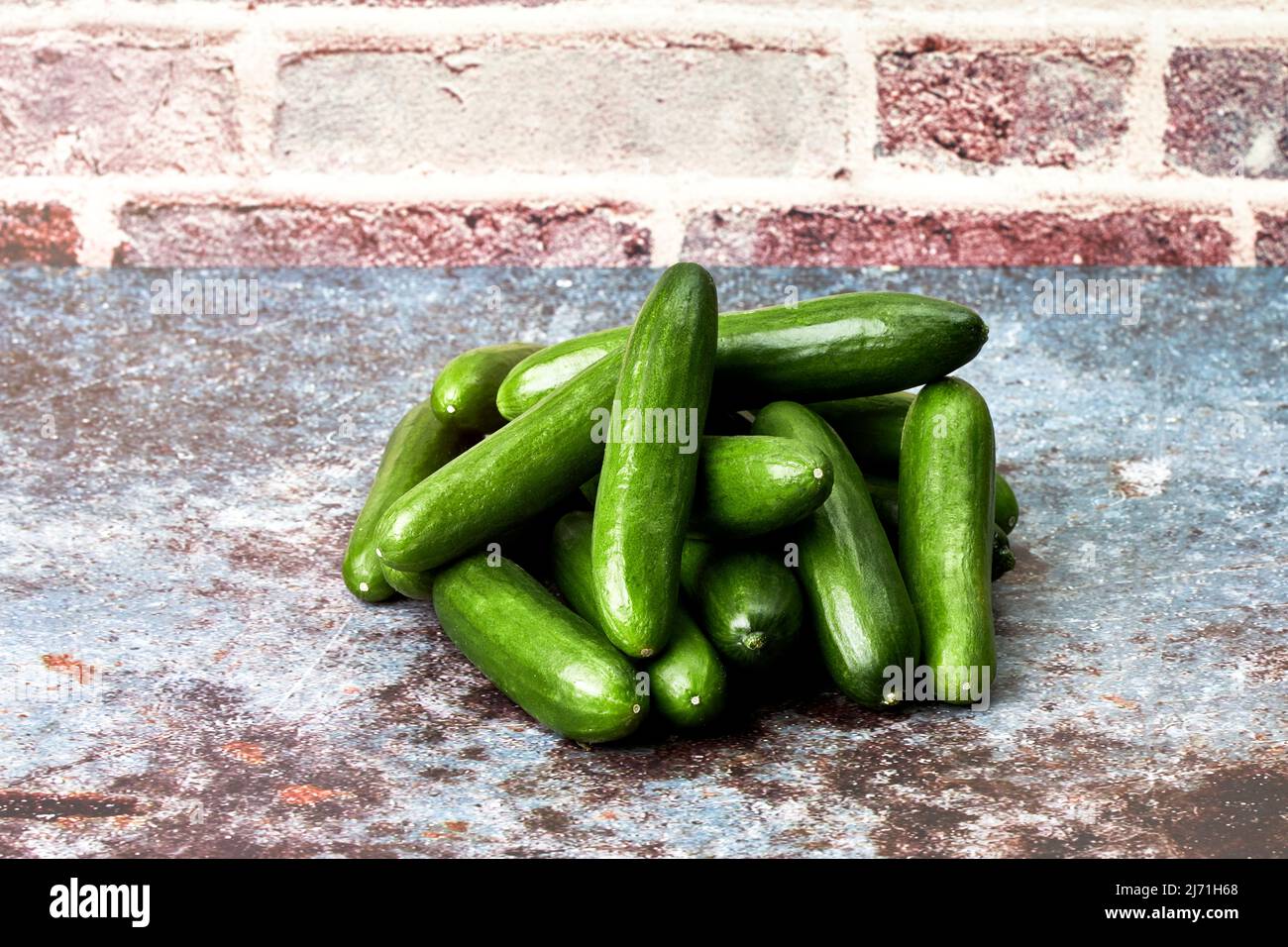 Pile of healthy and ecological baby cucumbers. Healthy snack food. Vegan and vegetarian food Stock Photo