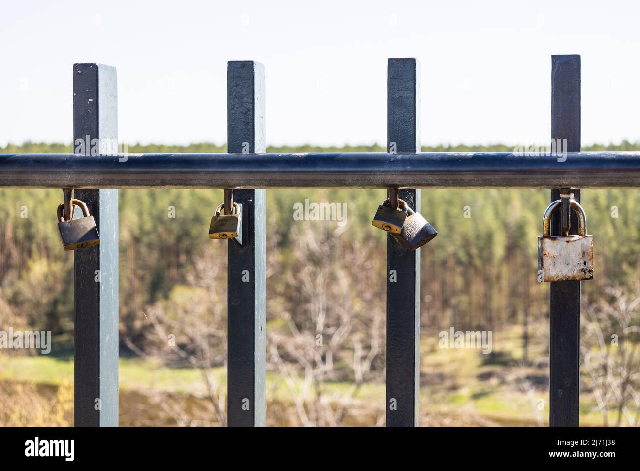 Closeup view of love padlocks hanging on a bridge fence Stock Photo - Alamy
