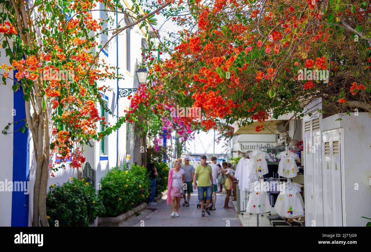2022 February 15-Street with white houses shown in Puerto de Mogan, Spain. Favorite vacation place for tourists and locals on island. Little suburban Stock Photo