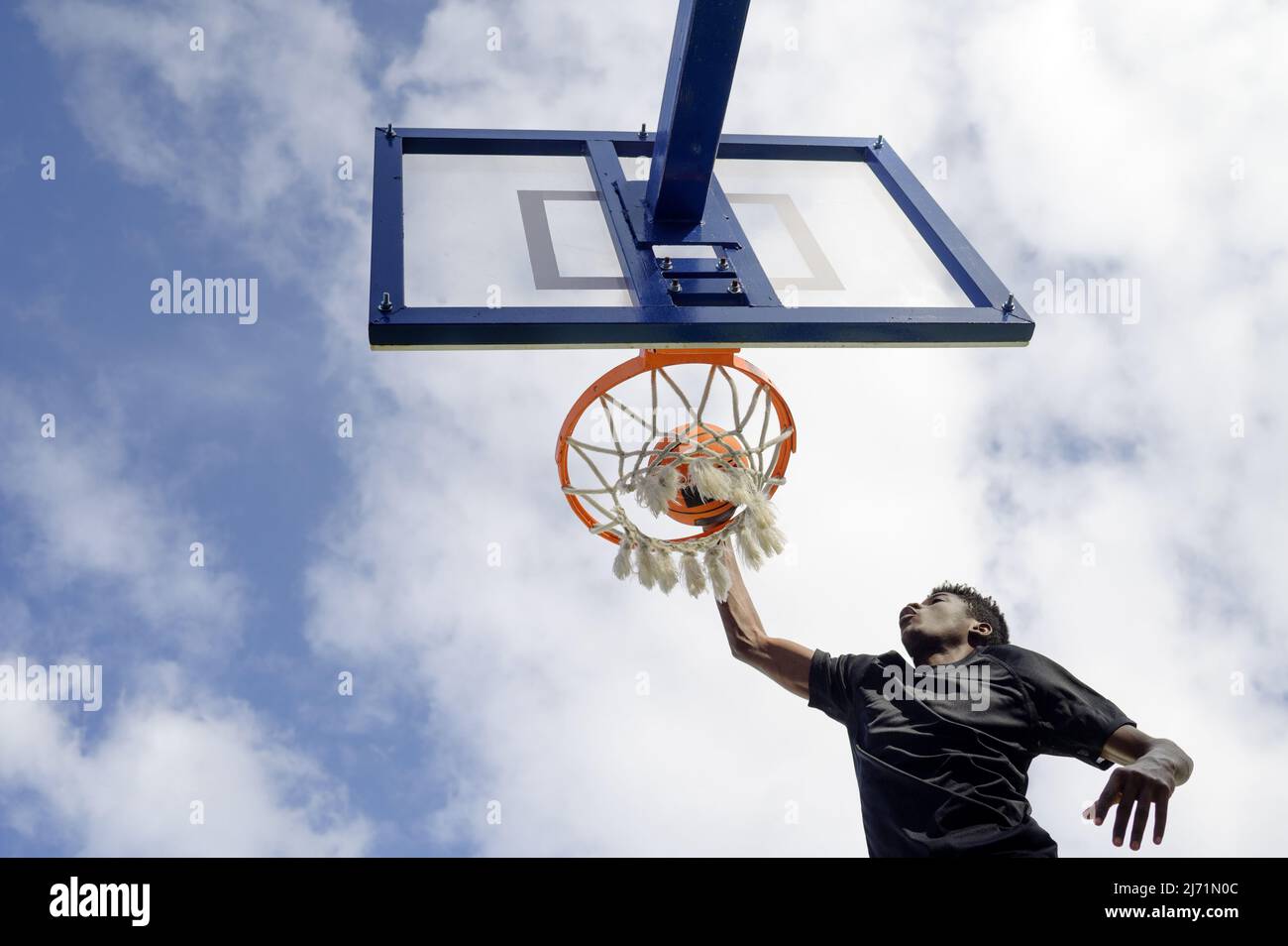African american basketball player dunks at the hoop Stock Photo Alamy