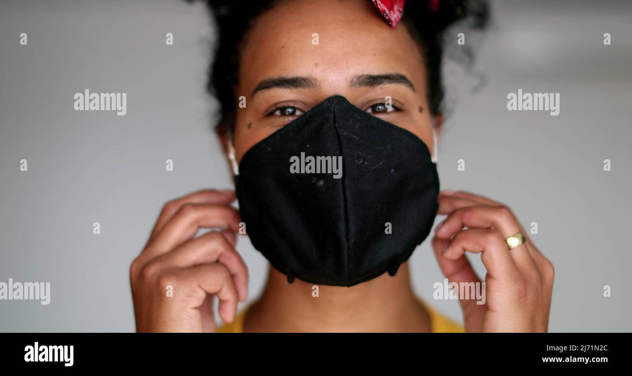 Happy young black woman taking off pandemic mask feeling relief Stock ...