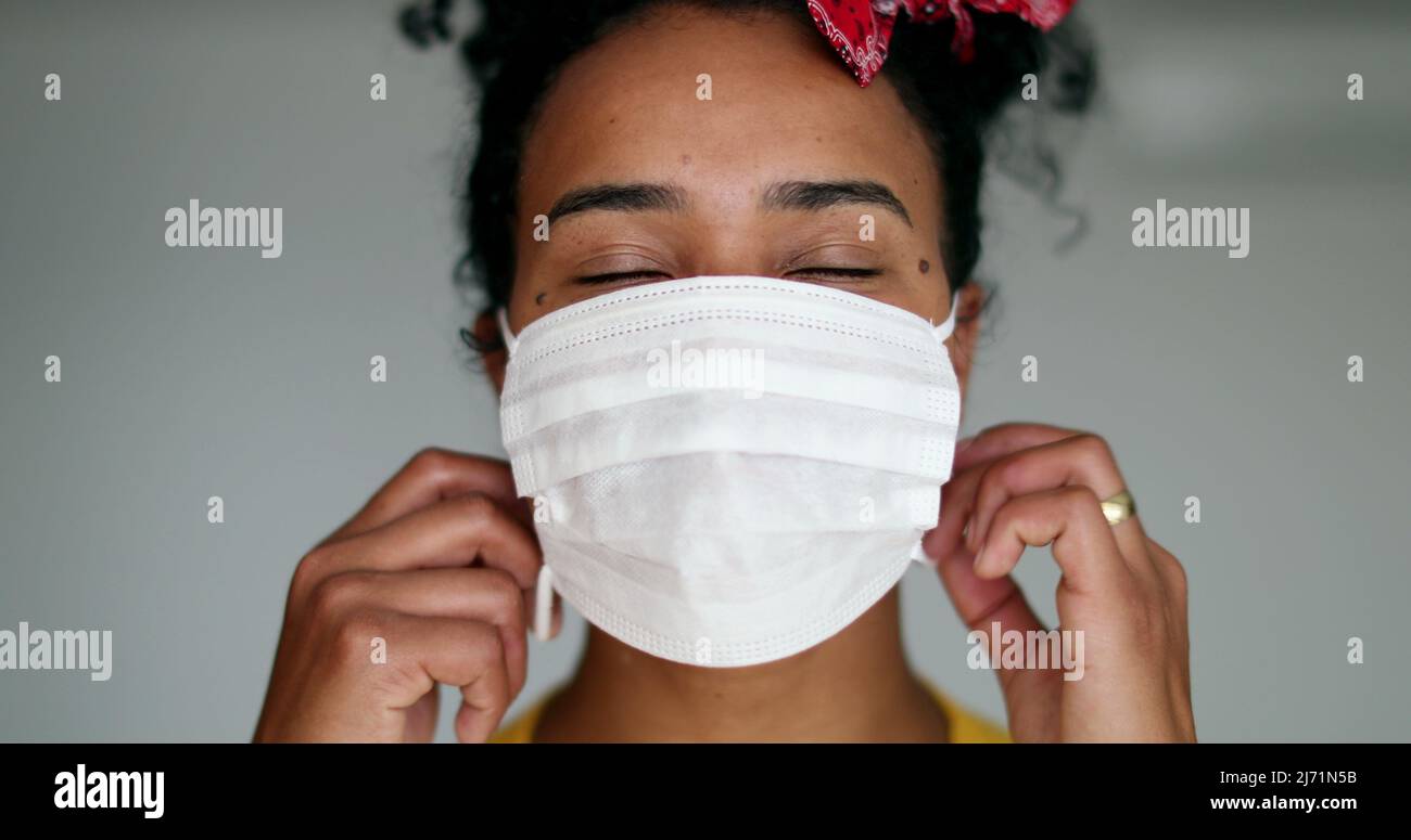 Happy young black woman taking off pandemic mask feeling relief Stock ...