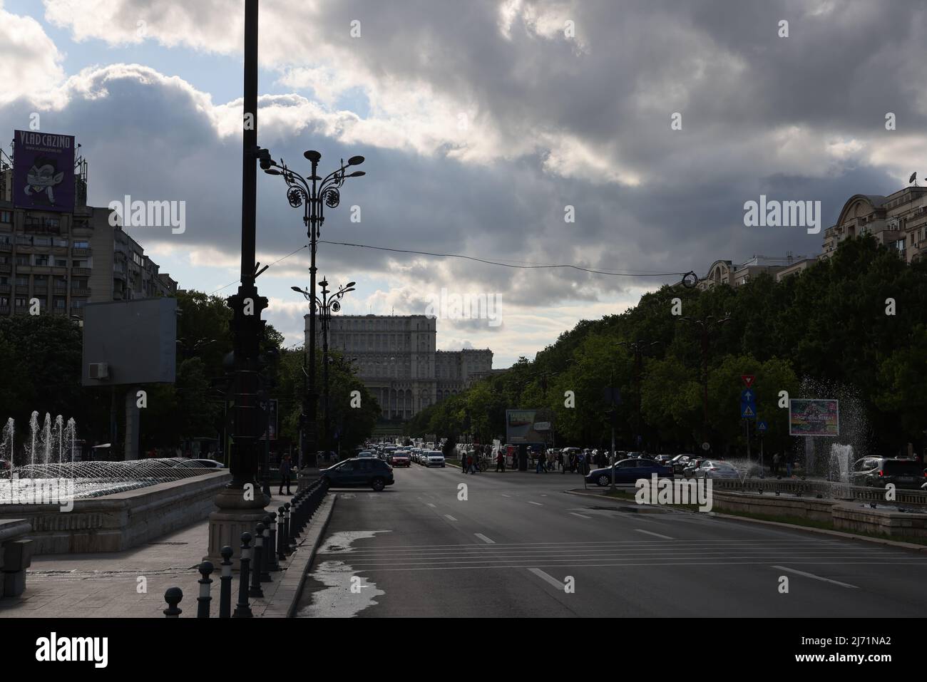 Dark clouds above House of the People  in Bucharest, Romania, which is the 2nd largest building in the world; seat of  Romanian parliament; conceptual Stock Photo