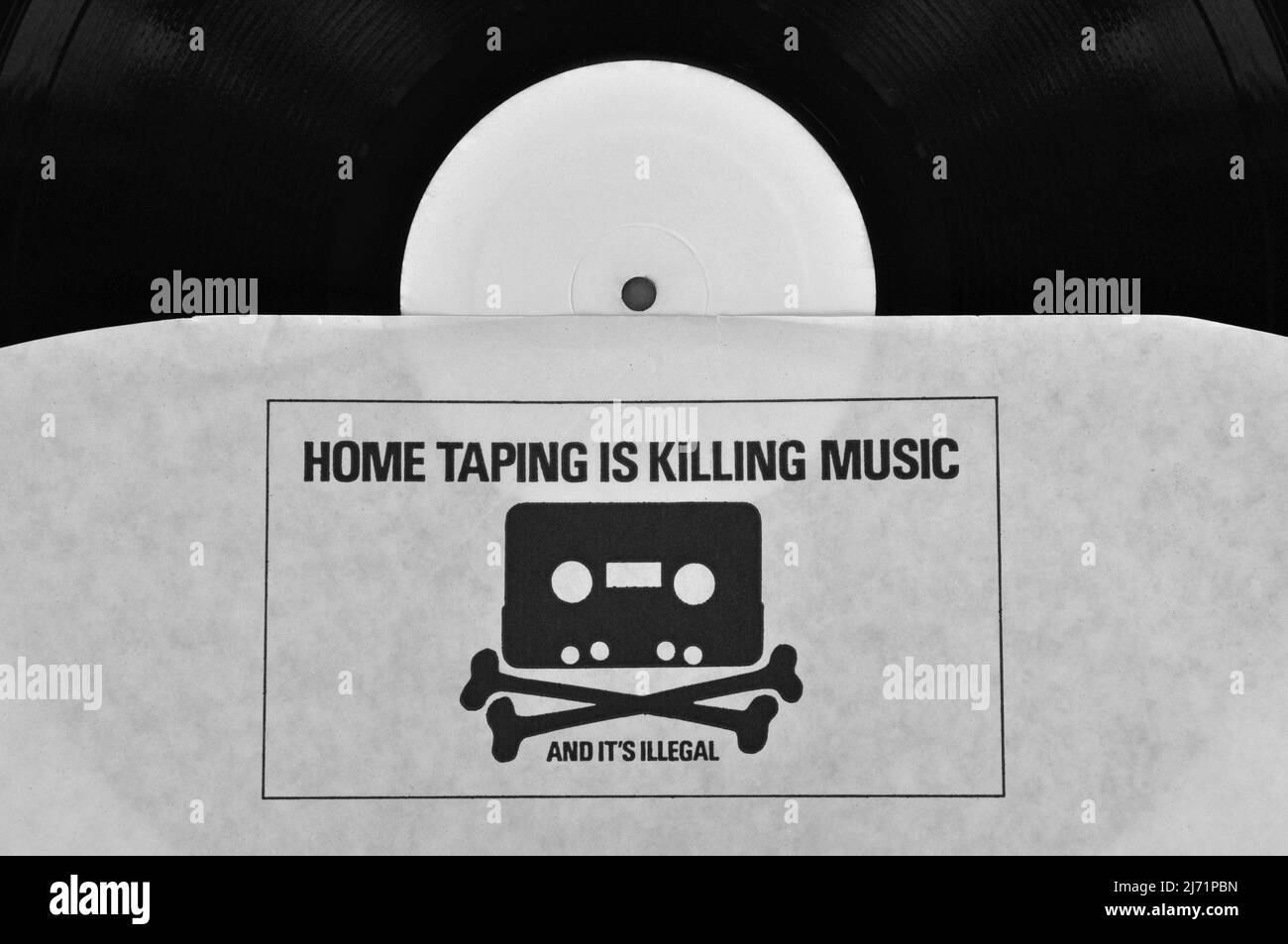 Athens, Greece - August 1, 2014: Home taping is killing music and it's illegal 1980s anti copyright infringement campaign printed on vinyl record inne Stock Photo