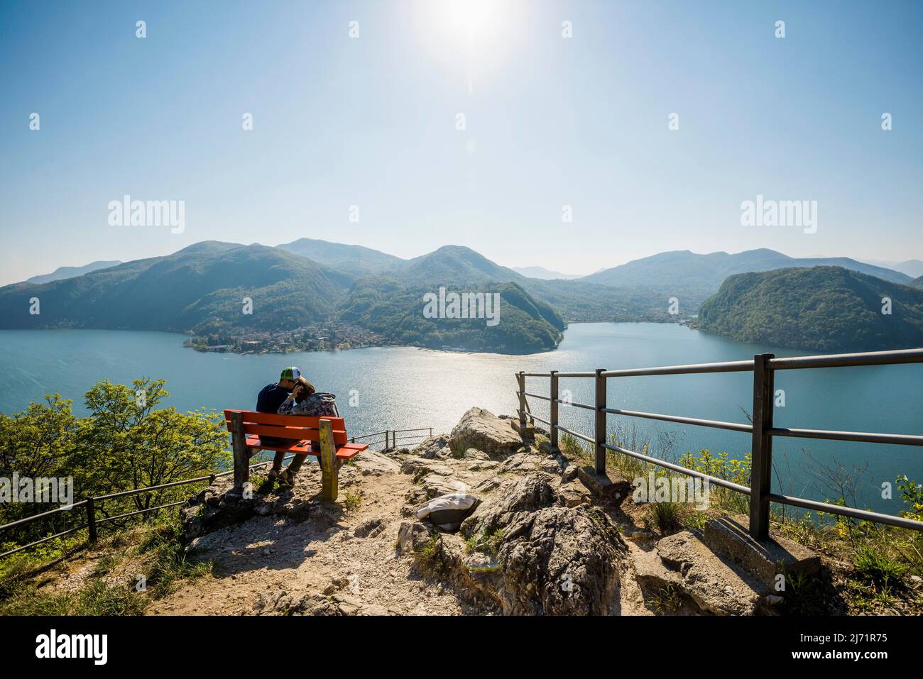Viewpoint with couple on a bench, Sasso Delle Parole, near Lugano, Lake Lugano, Lago di Lugano, Ticino, Switzerland Stock Photo