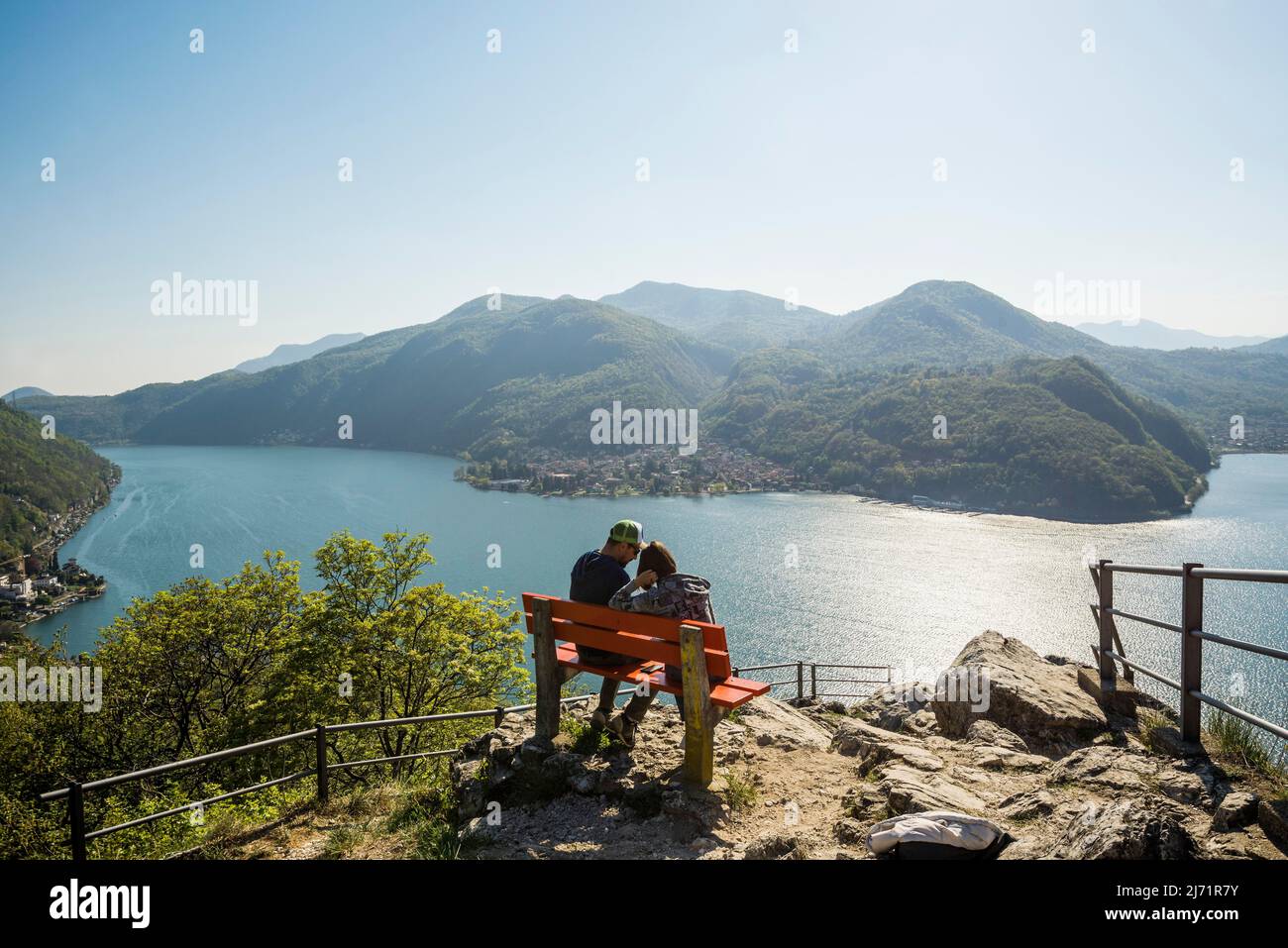 Viewpoint with couple on a bench, Sasso Delle Parole, near Lugano, Lake Lugano, Lago di Lugano, Ticino, Switzerland Stock Photo