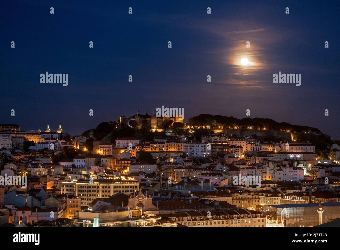 Moonrise over Lisbon, Portugal, seen from the Miradouro de São Pedro de Alcântara Stock Photo