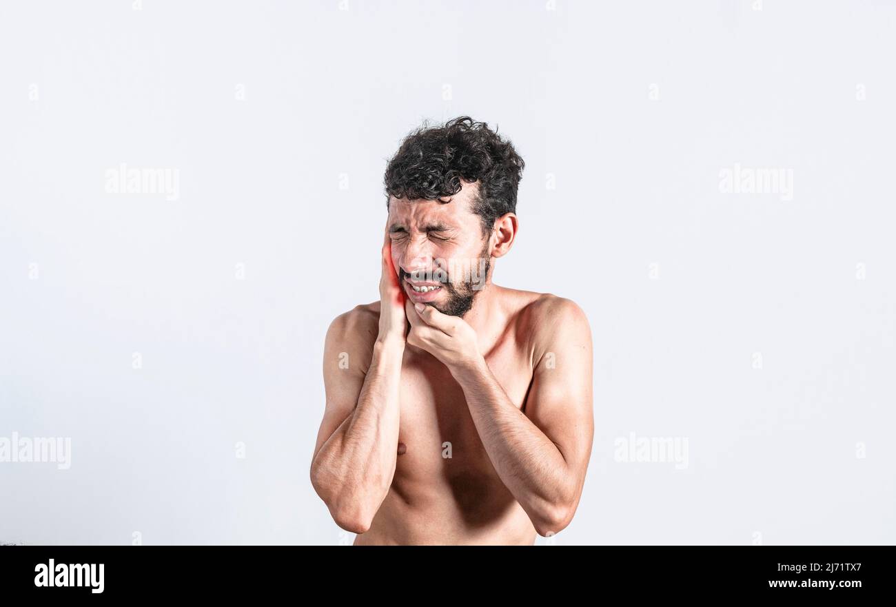 Person with earache on isolated background, man with earache on isolated background, ear disease concept Stock Photo