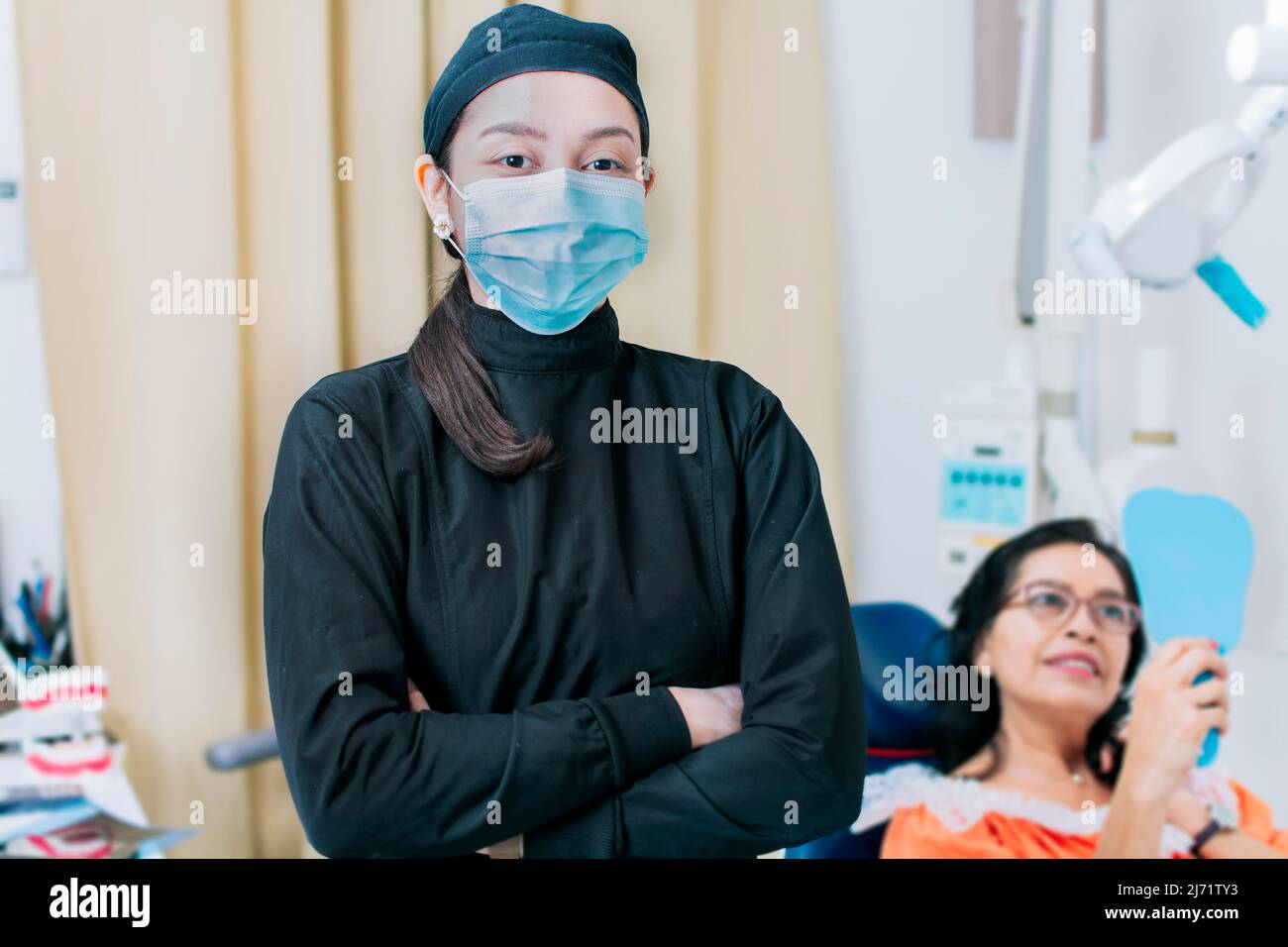 Dental doctor standing in clinic wearing mask, portrait of dentist