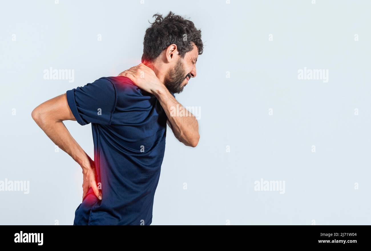 Man with spine and shoulder problems, person with back and shoulder problems on isolated background, lumbar and muscular problems concept Stock Photo