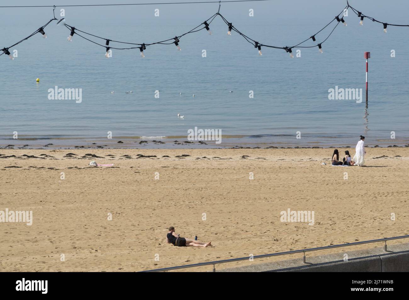 UK weather, Margate, Kent: A warm spell has started and the beach and saltwater lido at Margate are ready for visitors, with temperatures expected to reach 20c tomorrow. Sunshine, clear blue skies and calm water are already attracting people of all ages to the beach. Anna Watson/Alamy Live News Stock Photo