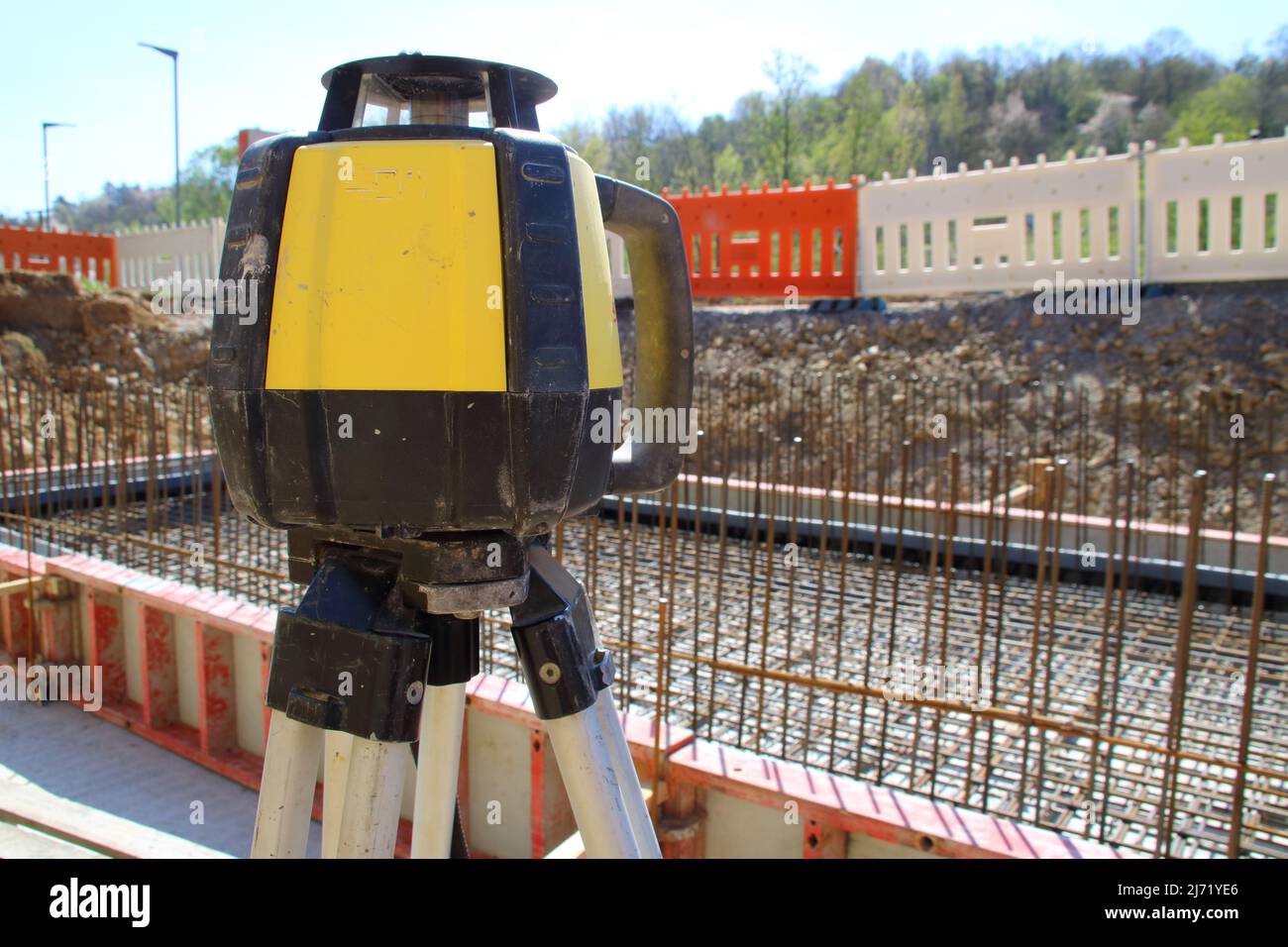 Leveling device for determining the height on a construction site with a planned background blur Stock Photo