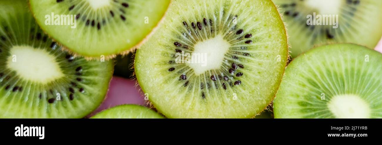 top view of sliced green kiwi on pink, banner Stock Photo - Alamy