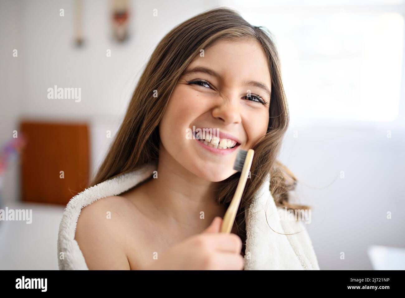 A Little girl brushing teeth in bathroom Stock Photo