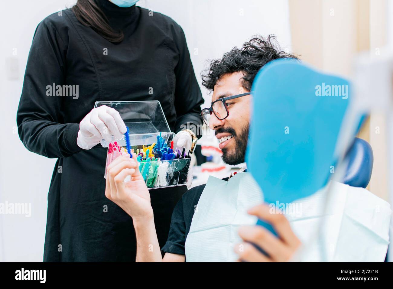 Patient with dentist choosing dental braces, Dentist with patient