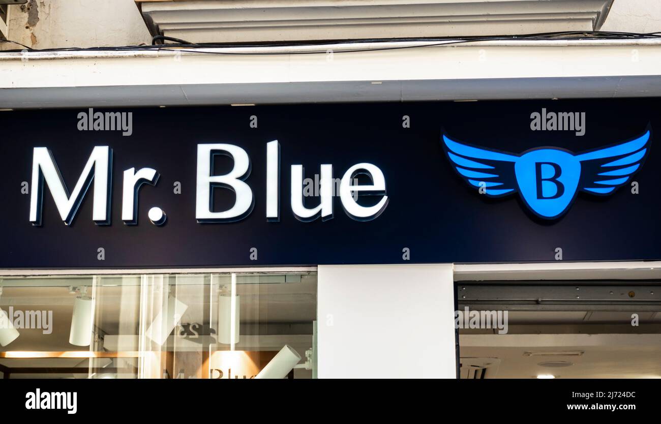 Logo of Mr Blue - Men's Clothing Store - on the store in Seville, Spain. Sign of Mr. Blue is a popular brand of menswear with winged logotype Stock Photo