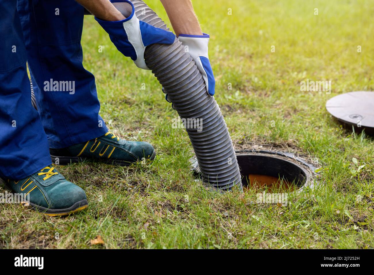pumping out household septic tank. drain and sewage cleaning service Stock Photo